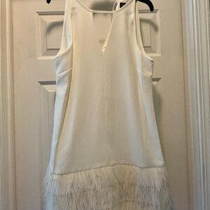Women’s white dress with feather trim